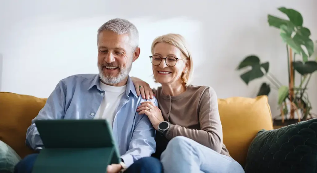 Couple looking at a tablet together on the couch