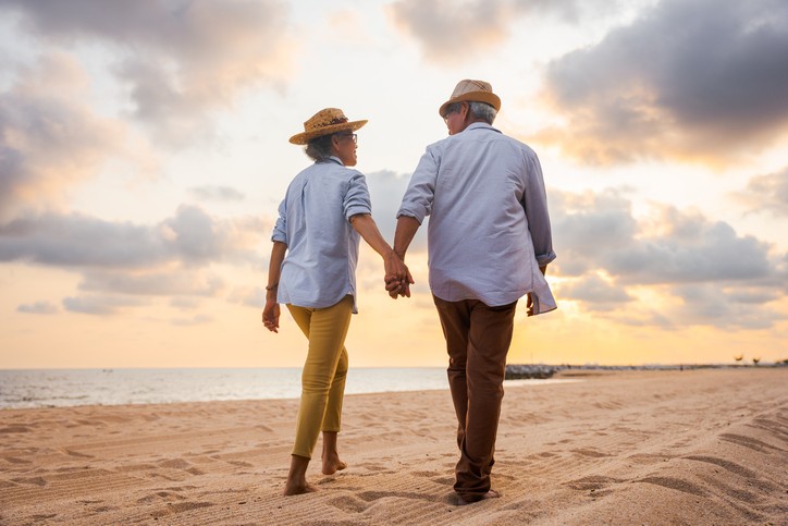 Senior couple walking along the beach